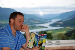 Ryan sitting at the dining room table, engrossed in Lonely Planet